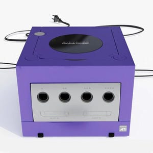 May include: A purple Nintendo GameCube console with a silver faceplate. The console has four controller ports, two memory card slots, and the GameCube logo on top. The power cable is plugged in.