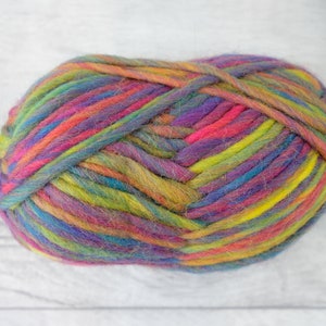 May include: A ball of colorful yarn with shades of pink, purple, blue, green, and yellow. The yarn is made of wool and is perfect for knitting or crocheting.