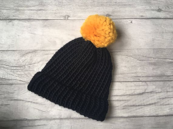 black and yellow bobble hat