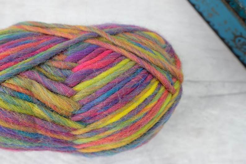 May include: A ball of colorful yarn with shades of pink, purple, blue, green, and yellow.