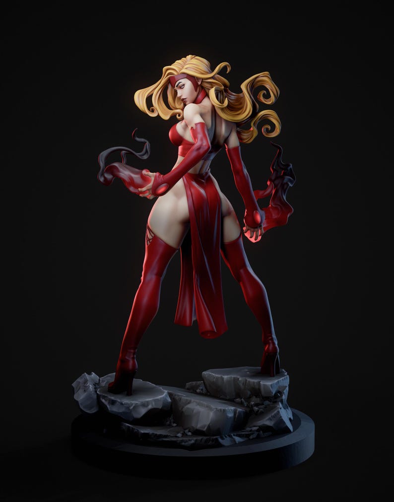 May include: A detailed figurine of a character in a dynamic pose, clad in a vibrant red outfit. The figure has long, flowing blonde hair and is standing on a rocky base. The overall aesthetic suggests a fantasy or comic book theme.
