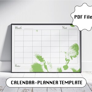 Peut inclure: Un modèle de calendrier horizontal avec un cadre noir, présentant une grille blanche pour les dates, des sections étiquetées Mois, Année et Notes, et un motif floral et papillon vert style aquarelle. Inclut un badge PDF Files.