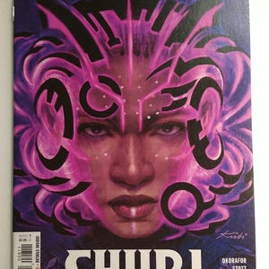 May include: Comic book cover featuring a close-up of a woman's face with pink and black abstract designs. The title "SHURI" is prominently displayed. The Marvel Comics logo and issue number 8 are visible.