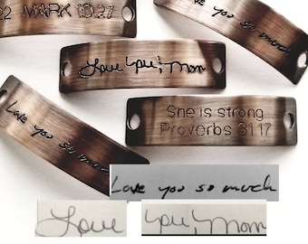May include: A set of six metal tags with different inscriptions. The tags are curved and have a brushed metal finish. The inscriptions include "Love you so much", "She is strong Proverbs 31:17", "Love you Mom", and "422 MARK 10:27".