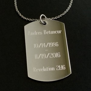 May include: Silver dog tag necklace with the inscription "Andres Betancur 10/14/1986 - 11/19/2016 Revelation 21:16"