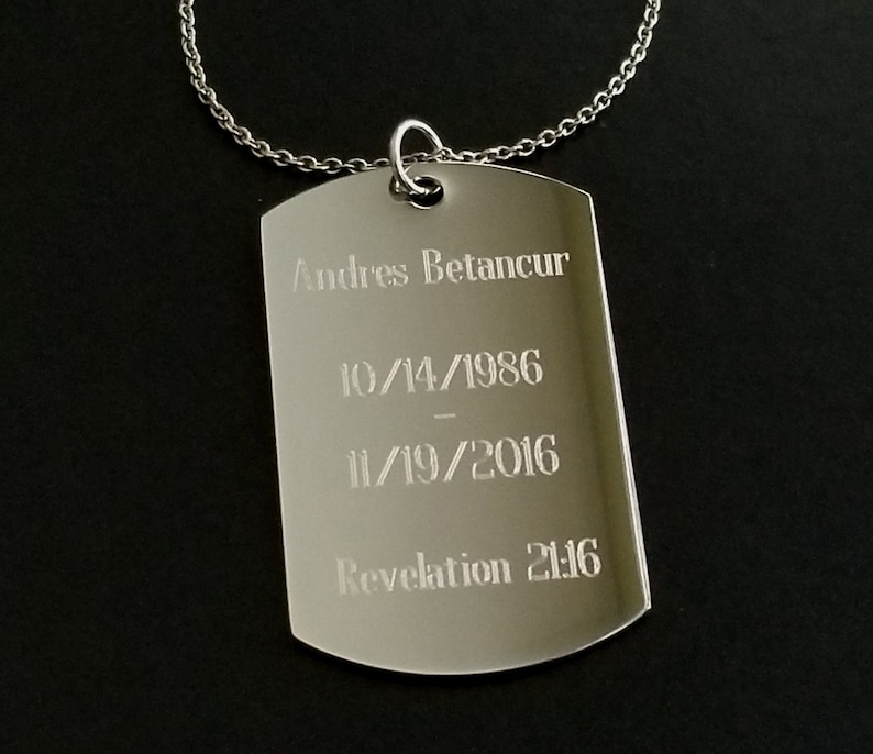 May include: Silver dog tag necklace with the inscription "Andres Betancur 10/14/1986 - 11/19/2016 Revelation 21:16"