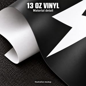 The image is a close-up of a piece of 13 oz vinyl material, with a black and white design on it.