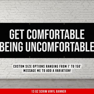May include: Black vinyl banner with white text that reads "GET COMFORTABLE BEING UNCOMFORTABLE".  The banner also includes the text "CUSTOM SIZE OPTIONS RANGING FROM 1' TO 150' MESSAGE ME TO ADD A VARIATION!" and "13 OZ SCRIM VINYL BANNER".