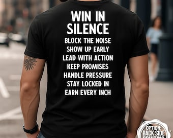 May include: Black t-shirt with white text: "WIN IN SILENCE, BLOCK THE NOISE, SHOW UP EARLY, LEAD WITH ACTION, KEEP PROMISES, HANDLE PRESSURE, STAY LOCKED IN, EARN EVERY INCH." The shirt also has a small graphic that says "OPTION: BACK SIDE PRINTING AVAILABLE."