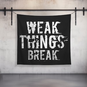 May include: Black tapestry with white text that reads "WEAK THINGS BREAK" in a distressed font.