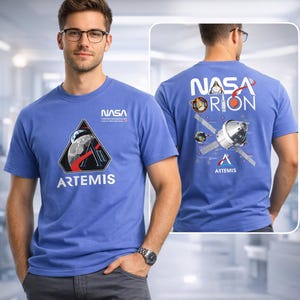 May include: A blue t-shirt featuring the NASA logo and the word "ARTEMIS" in white. The front of the shirt displays a triangular graphic with a space-themed design. The back of the shirt has the words "NASA ORION" and a diagram of a spacecraft.