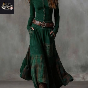 May include: A white ceramic mug with a black handle and the text "But First, Coffee" in a bold, black font. The mug is set against a blurred background, suggesting a cozy setting.