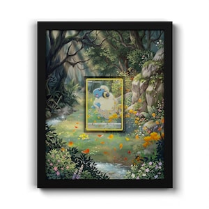 May include: A black framed shadow box containing a trading card featuring a blue and white creature with yellow accents. The card is centred over a detailed illustration of a lush forest landscape with a stream, rocks, and colourful wildflowers.