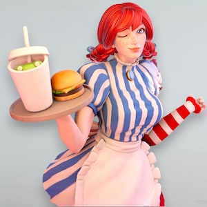 Könnte beinhalten: Figur einer Frau mit roten Zöpfen, die zwinkert, ein blau-weiß gestreiftes Kleid und eine weiße Schürze trägt. Sie hält ein Tablett mit einem Burger und einem Getränk mit einem grünen Frosch darin. Die Figur hat einen rot-weiß gestreiften Ärmel.