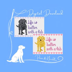 May include: Digital download featuring two cross-stitch designs with Labrador Retrievers. One design shows a black Lab, the other a yellow Lab, both with the text "Life is better with a lab." The background is light blue.