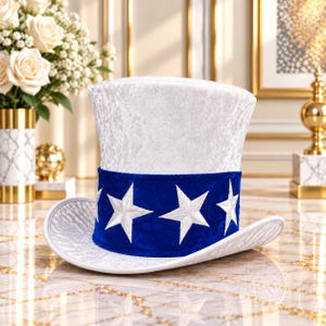 May include: A white top hat with a textured, crushed velvet-like finish. The hat features a wide, vibrant blue band around the base, decorated with several embroidered white five-pointed stars evenly spaced around the circumference.