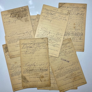 May include: A collection of aged, vintage shipping forms from The Pittsburgh, Cincinnati, Chicago & St. Louis R'y Co. The forms are tan with handwritten text, signatures, and dates from 1891. The forms are stacked and overlapping.
