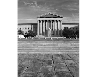 May include: A black and white photograph of a large, classical building with a fountain in front of it. The building has a large, central dome and a series of columns.