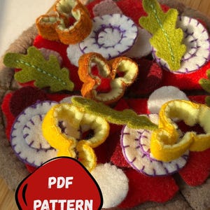 May include: A felt pizza set pattern with colorful felt toppings, including orange, yellow, white, and green shapes. The pizza base is a light brown color. The text "FELT PIZZA SET PATTERN" is at the top, and "PDF PATTERN" is in a red shape at the bottom.
