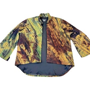 May include: A multi-colored open jacket with a unique pattern. The jacket features a mix of brown, yellow, and green hues, with a textured, pleated design. It has long, flared sleeves and a black lining, creating a striking visual contrast.