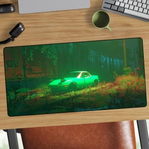 May include: A green sports car is the focal point of this mousepad, set against a backdrop of a train and overgrown vegetation. The car is illuminated, creating a striking contrast with the darker surroundings. The mousepad is rectangular.