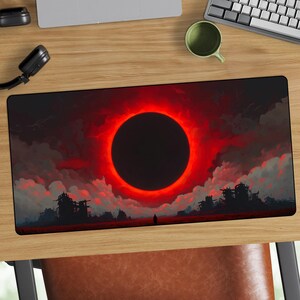 May include: A rectangular mouse mat with a striking design. It depicts a black circle surrounded by a red glow against a cloudy, red sky. Silhouetted figures and structures are at the bottom, with a lone figure in the center. The design has a dark fantasy theme.