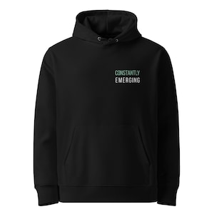 May include: Black hooded sweatshirt with a front pocket and drawstring. The text "CONSTANTLY EMERGING" is printed in a teal color on the upper left chest area. The hoodie has a classic, casual design.