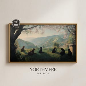 May include: A framed print of a landscape with six black cats on a grassy hill. The artwork features a gold frame, a scenic view of rolling hills, and the text "NORTHMERE PRINTS". The print has a vintage aesthetic.