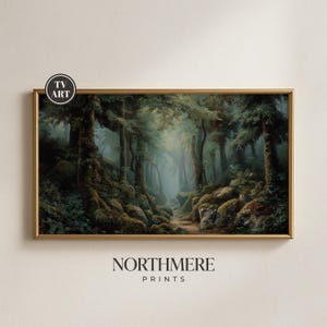 May include: A rectangular landscape print in a gold frame depicting a dense, misty forest with moss-covered rocks and tall trees. The image features a small circular logo in the top left corner reading TV ART and the text NORTHMERE PRINTS below.