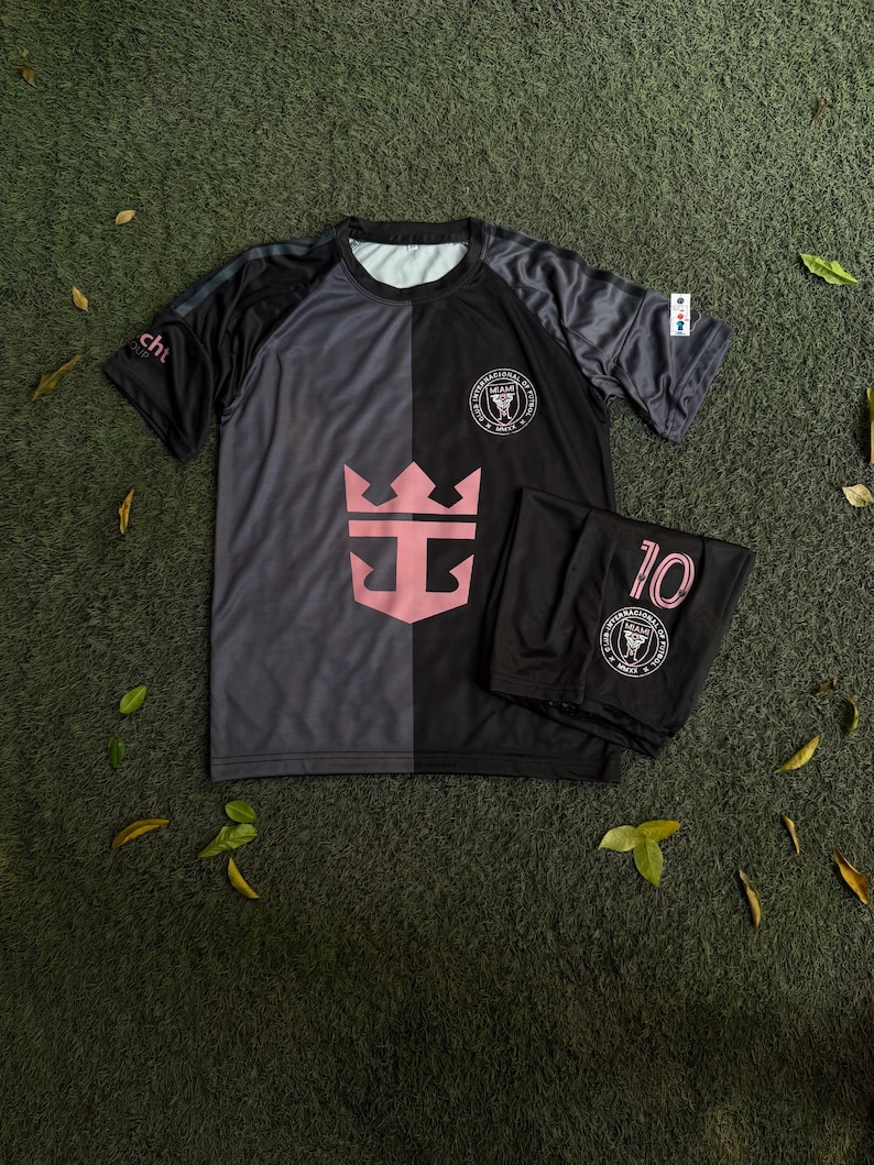 May include: A short-sleeve athletic shirt and matching shorts set in black and dark gray. The shirt features a large pink crown logo, the Inter Miami CF crest, and the text "cht" on the sleeve. The shorts display the number 10 and the team crest.