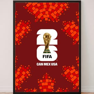 May include: A framed poster featuring a dark red background with a repeating orange pixelated pattern. In the center, a large white 26 incorporates the FIFA World Cup trophy, with the text FIFA and CAN MEX USA printed below in white.
