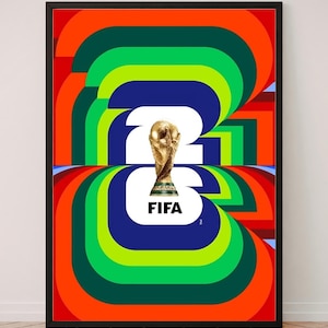 May include: A framed poster featuring a vibrant, multi-colored graphic design with concentric, rounded shapes in orange, green, and blue. Centered is a white graphic of the number 26, the FIFA World Cup trophy, and the text FIFA in black.