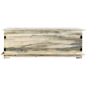 May include: A large, rectangular wooden storage chest with a light, weathered finish. The chest features a hinged lid, decorative black metal accents, and sits on a low base. The wood grain is visible, adding to its rustic charm. Suitable for storing blankets or other items.