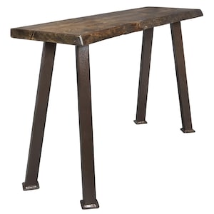 May include: A rustic, rectangular wooden table with a dark brown finish. The tabletop rests on four angled, dark metal legs. The table is approximately 48 inches long and 12 inches wide, making it suitable for a hallway or entryway.