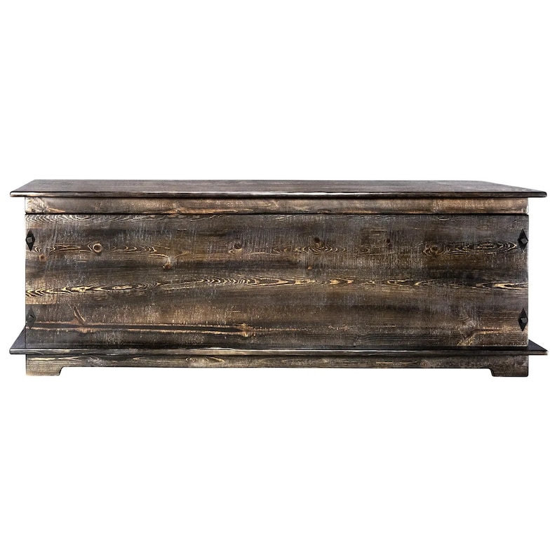 May include: A large, rectangular wooden chest with a dark, weathered finish. The chest has a flat top and a base, with visible wood grain and metal accents on the front. The design suggests a rustic or farmhouse style.