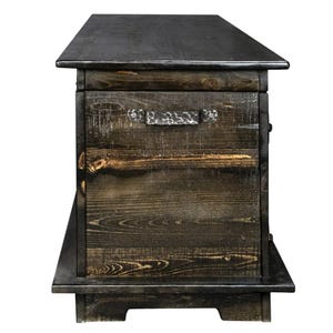 May include: A distressed wooden sign with the words "Welcome to our home" in white lettering. The sign has a rustic finish, ideal for adding a welcoming touch to any home's entrance.