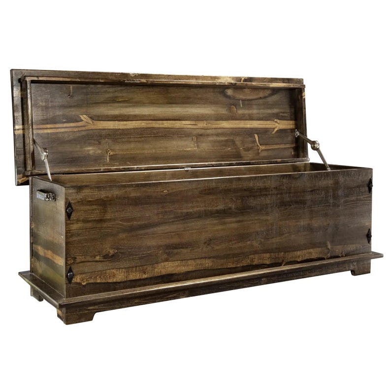 May include: A large, open wooden chest with a hinged lid. The chest is made of dark brown wood with visible grain and is rectangular in shape. The lid is propped open, revealing the interior. The chest sits on a low base and has metal hardware.