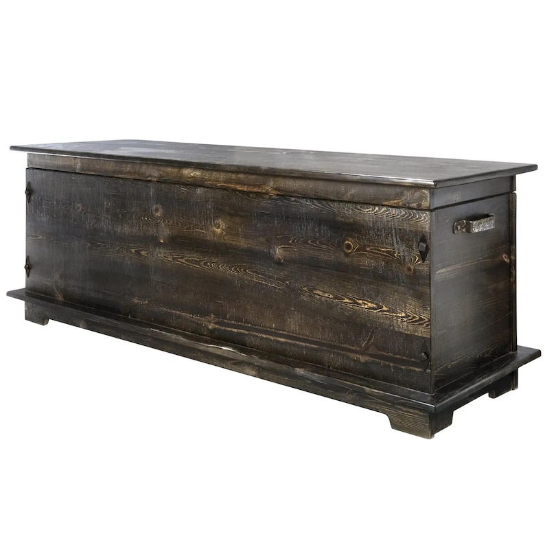 May include: A dark stained wooden storage chest. The rectangular chest has a flat top, a base, and metal handles. The wood grain is visible, and the chest appears handcrafted. The chest is approximately 150 cm long.