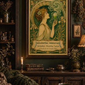 May include: A framed art print featuring an Art Nouveau style illustration of a person holding a glass of green liquid. The text reads Absinthe Mimeux, Veritable Absinthe Suisse, and EXPOSITION PARIS 1889, surrounded by green and gold floral motifs.