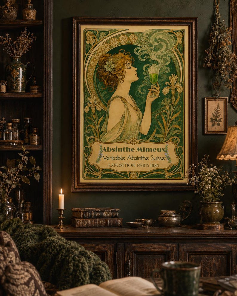 May include: A framed art print featuring an Art Nouveau style illustration of a person holding a glass of green liquid. The text reads Absinthe Mimeux, Veritable Absinthe Suisse, and EXPOSITION PARIS 1889, surrounded by green and gold floral motifs.