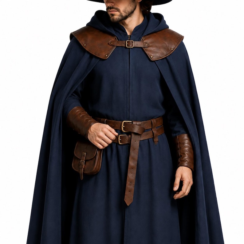 May include: A dark blue hooded cloak featuring brown leather shoulder pauldrons with a buckle closure. The outfit includes a matching brown leather belt with a small attached pouch and brown leather wrist bracers, all secured with metal buckles.