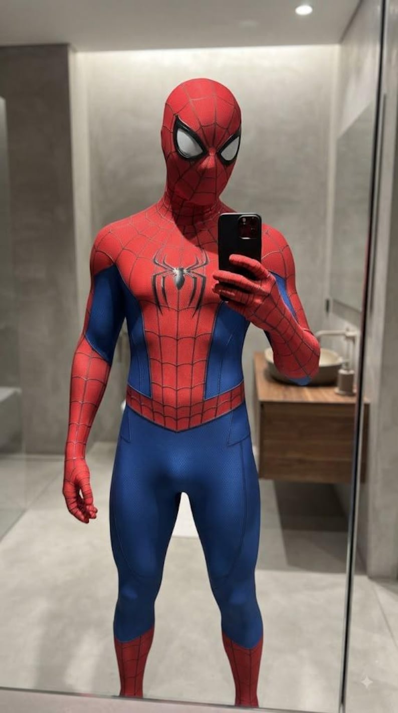May include: A full-body Spider-Man costume featuring a red and blue spandex-like material with a black web pattern printed across the red sections. The suit includes a mask with large white eye lenses and a black spider emblem centered on the chest.