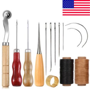 May include: A leathercraft tool kit featuring various tools, including needles, awls, a rotary cutter, and spools of black and tan thread. A gold thimble and curved needles are also included. The tools have wooden and metal components.