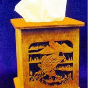May include: Wooden tissue box cover with a cutout design of a fish jumping out of the water. The design includes reeds and mountains in the background.