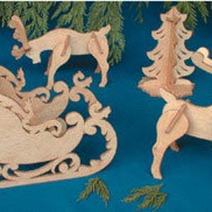 May include: Wooden Christmas craft kit featuring a sleigh, two reindeer, and a Christmas tree. The pieces are cut out and ready to be assembled.