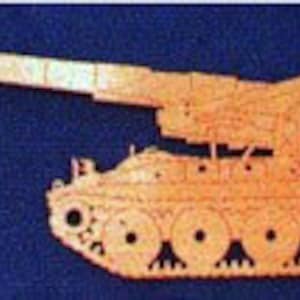 May include: A wooden model of a self-propelled howitzer artillery piece. The model is painted in a light brown color and has a long barrel and a detailed design.