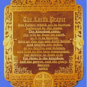 May include: Wooden plaque with the text of The Lord's Prayer, framed by ornate carvings. The plaque is a warm brown color with a gold-colored cross at the bottom. The text is in a classic font.