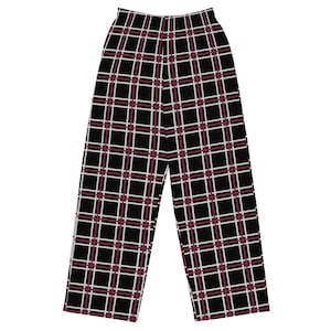 May include: Full-length trousers featuring a black base with a repeating plaid pattern. The design consists of thin white and dark red intersecting lines that create a grid across the fabric. The pants have a high-waisted cut with a straight leg.