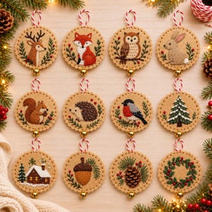 May include: Twelve circular felt ornaments featuring embroidered woodland motifs including a deer, fox, owl, rabbit, squirrel, hedgehog, bird, pine tree, cabin, acorn, pinecone, and wreath, each with a red and white string and gold bell.