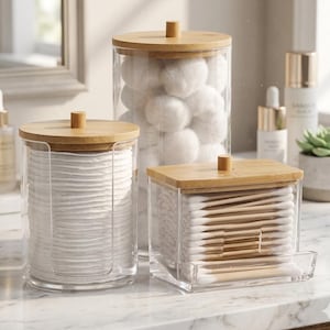 May include: A set of three ceramic mugs with a speckled, matte finish. The mugs are in shades of cream, light gray, and dark gray. Each mug has a simple, minimalist design and a rounded handle. The mugs are stacked on top of each other.